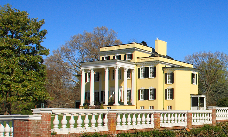 Photo of the front of the mansion from the garden showing the balustrade in the foreground.